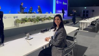 Alumna sitting at a desk at the UN