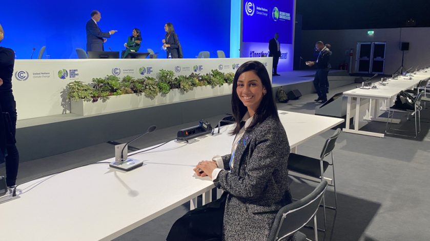 Alumna sitting at a desk at the UN