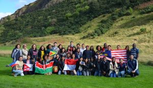 Scholars gather and hold flags in Edinburgh.