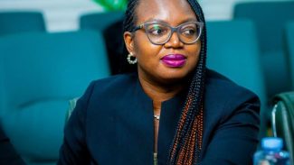 Elizabeth sitting in a business setting.